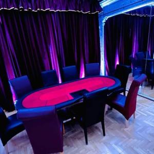 a ping pong table in a room with purple curtains at Private Party Villa in Budapest