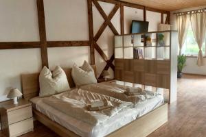 a bedroom with a large bed with a wooden headboard at Ruegen Fewo 66 2 in Kasnevitz
