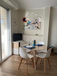 a dining room with a table and chairs at Attico Gabri - Appartamento con terrazzo panoramico vicino al Centro in Turin