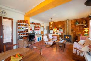 a living room with a table and a fireplace at Bonavista (Batle De Bonavista) in Felanitx