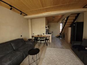 a living room with a couch and a table at Townhouse in Mountains. in Bakuriani