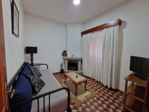 a living room with a couch and a fireplace at Casa Feijao - Alojamento Local in Geres
