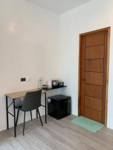 a table and a chair and a table and a door at Oceanarra Beach Hotel and Resort Inc. in San Luis +20 photos