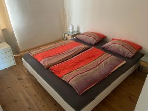 a bed with two pillows on it in a bedroom at Apartmenthaus Schlanow in Detmold