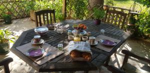 a wooden table with food and fruit on it at Maison Anne face to park in Vernon Giverny in Vernon