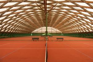 a tennis court with two benches and an umbrella at Ap.Galerija Istok-Zapad 2 - "Very cozy" in Rovinj