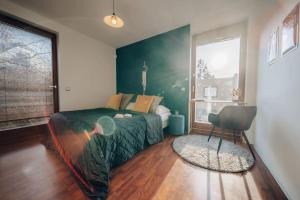 a bedroom with a bed and a chair in it at Design 3BD apartment cooking area in architect villa in Prague