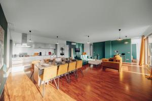a kitchen and living room with a table and chairs at Design 3BD apartment cooking area in architect villa in Prague