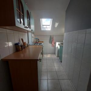 a small kitchen with a counter and a window at Pokoje Gościnne u Huberta in Soblówka