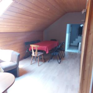 a dining room with a table and chairs in a room at Pokoje Gościnne u Huberta in Soblówka