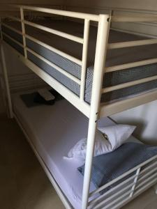 a bunk bed with a pillow on the bottom bunk at House by the Sea at Skaloma, Loutraki in Vouliagmeni Lake