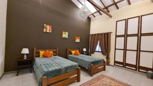 a bedroom with two beds and a window at Luxury holiday villas in Bahrain for Families in Bārbār