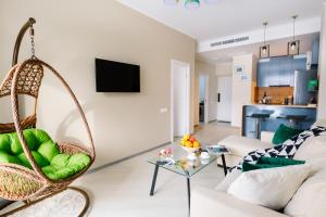 a living room with a hanging chair and a couch at hotelise l Mountain View in Tsaghkadzor