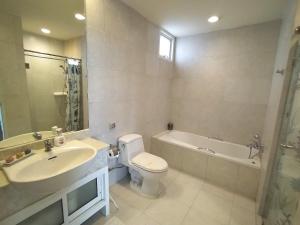 a bathroom with a sink and a toilet and a tub at Baan Sanploen Huahin Condo By KK in Hua Hin