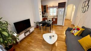 a living room with a couch and a tv at Picassia Home Malaga Center in Málaga
