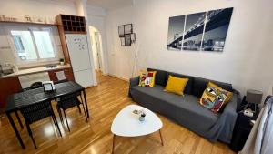 a living room with a couch and a table at Picassia Home Malaga Center in Málaga