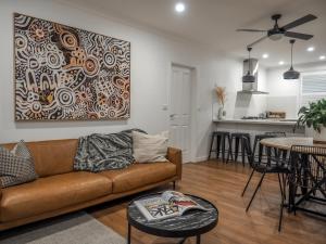 a living room with a couch and a table at Central Bendigo Cottage Charm in Bendigo
