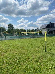 a volleyball court with a net in a field at Villa Stone in Rakovica