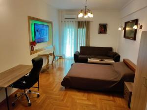 a living room with a bed and a couch and a table at VeryBeautifulSpaciousAppartment in Athens