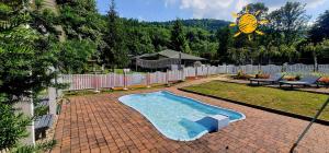 a swimming pool in a backyard with a fence at Cicha Dolina in Międzybrodzie Bialskie