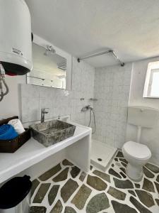 a bathroom with a sink and a toilet at Motivo Sea Side in Sifnos