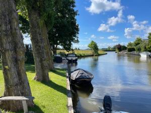 kilka łodzi zaparkowanych na brzegu rzeki w obiekcie Harlingen Staete Wellness B&B Oase van rust en luxe w mieście Harlingen
