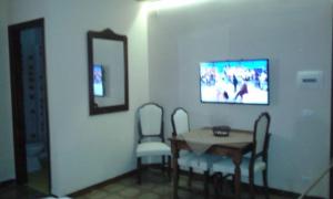 a dining room with a table and chairs and a mirror at Casa Rosanna in Terrasini