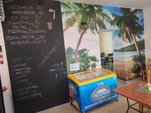 a menu on a wall next to a table at Gościniec IBIS in Czarna Wieś