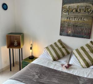 a bedroom with a bed and a picture on the wall at Bomboniera a due passi dal mare-FH in San Benedetto del Tronto