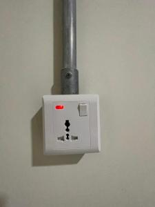 um interruptor de luz com uma luz vermelha na parede em Ommi Hostel em St. Julian's
