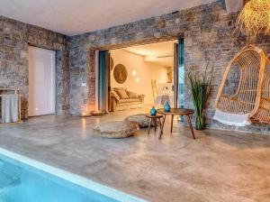 a living room with a table and a couch at Panormos Village Hotel in Mykonos