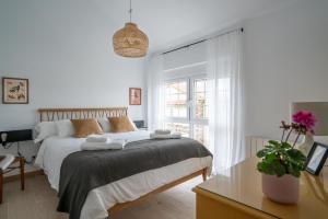 Un dormitorio blanco con una cama y una ventana. en Montealmar - Natural Stays Somo, en Galizano