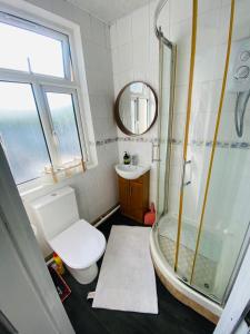 a bathroom with a shower and a toilet and a sink at Studio in central London in London