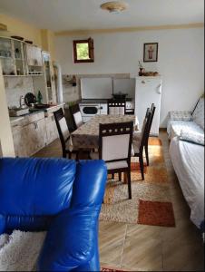 a living room with a table and chairs and a kitchen at DRAGICA Manastirska 10 in Ljubovija