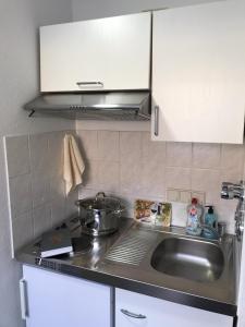 a kitchen with a sink and a counter top at Schönes zentrales Appartment mit TIEFGARAGE in Kassel