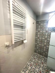 a bathroom with a tile floor and a window at Esmeralda Apartment With Free Private Underground Parking in Valencia