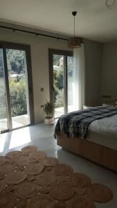 a bedroom with a bed and a rug on the floor at Suna Summer House in Marmaris