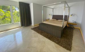 a bedroom with a bed and a large window at Ibiza 7th Heaven Villa in Sant Josep +31 photos