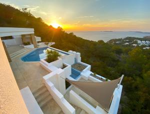 a villa with a view of the ocean at sunset at Ibiza 7th Heaven Villa in Sant Josep