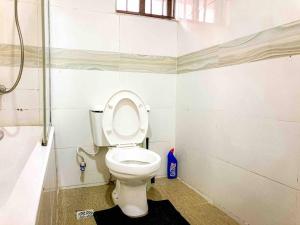 a bathroom with a toilet and a shower at Beautiful Studio -3 mins walk to the Beach in Lagos