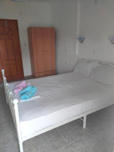 a white bed with two pillows on top of it at Vigla House in Sykia Chalkidikis