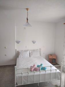 a white bed with two flip flops on it at Vigla House in Sykia Chalkidikis