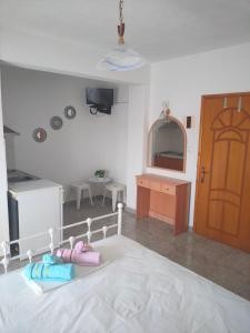 a bedroom with a bed and a kitchen and a door at Vigla House in Sykia Chalkidikis