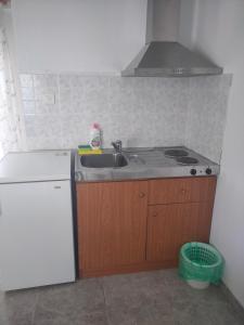 a small kitchen with a sink and a stove at Vigla House in Sykia Chalkidikis