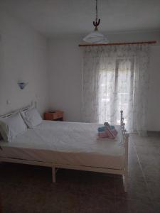 a bed with a pair of shoes sitting on it at Vigla House in Sykia Chalkidikis