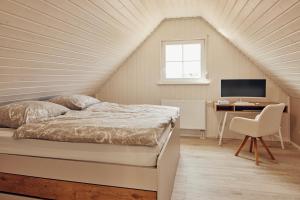a bedroom with a bed and a desk with a computer at Schorfheide - Ferienhaus mit Sauna und Hot Tub Whirlpool! Energiekosten flat in Wandlitz