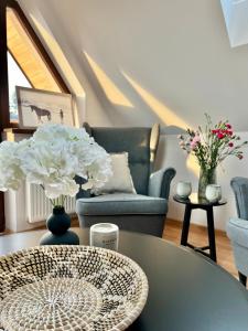 a living room with a table and a couch at Nosal Ski & Wine Apartments in Zakopane