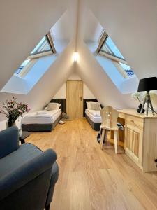 a attic living room with skylights at Nosal Ski & Wine Apartments in Zakopane