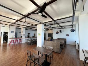 a room with a table and chairs and a bar at Oceanarra Beach Hotel and Resort Inc. in San Luis