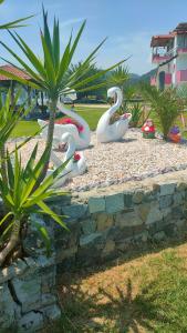 a group of fake swans in a park at Vigla House in Sykia Chalkidikis